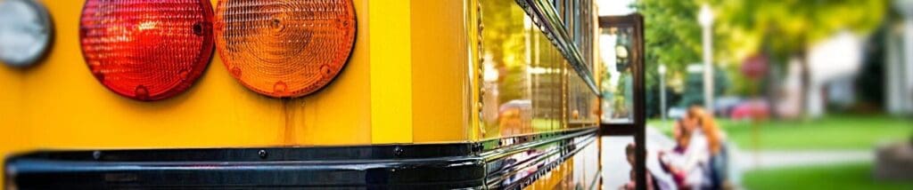 Side view of a yellow color bus with children